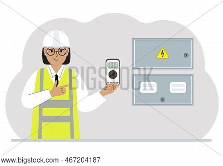 A Female Electrical Engineer Holds A Digital Multimeter In His Hand And Stands Next To An Electrical