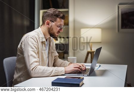 Young Caucasian Businessman In Eyglasses Working On Computer At Home, Remote Employment