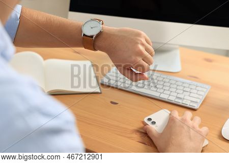 Man Checking Time At Desk In Office, Closeup. Being Late
