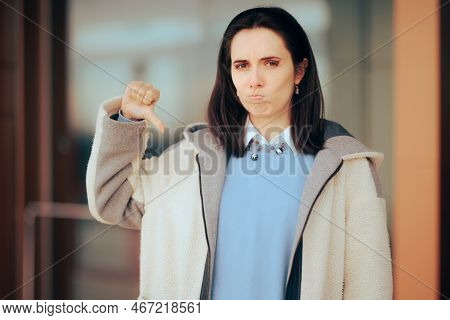 Unhappy Sad Woman Holding Thumbs Down Outdoors