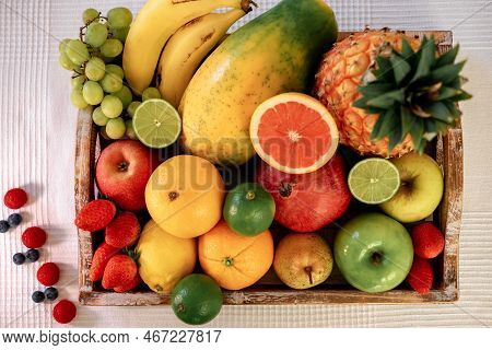 Close-up On A Wooden Basket Full Of Colorful Fresh Fruit.  Healthy Nutrition And Lifestyle Concept.