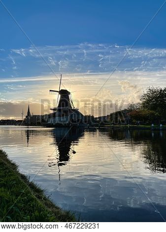 Den Haag, Netherlands - November 04 2021 : The Silhouette Of A Classic Typical Dutch Wind Mill Along