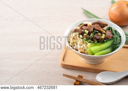 Beef Noodle Soup. Taiwanese Famous Food In A Bowl On Wooden Table.