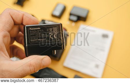 Paris, France - Nov 20, 2022: Male Hand Holding Lumix Vsk0815l Charger For Rechargable Li-ion Batter