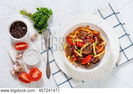 Lomo Saltado, Peruvian Dish Of Stir-fried Slices Of Beef Sirloin, Onions, Yellow Peruvian Chilis, An