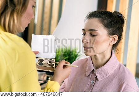Beauty Stylist Applying Make-up To A Young Model.professional Make-up Artist Doing Glamour