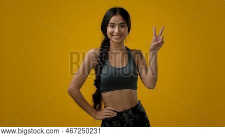 Smiling Ethnic Indian Sport Woman Girl Lady Female Athlete In Yellow Studio Background Show Double F