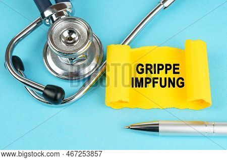 Medical Concept. On The Blue Surface There Is A Stethoscope, A Pen And A Yellow Sticker With The Ins