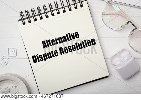 Notepad With Text Alternative Dispute Resolution On White Table, Flat Lay