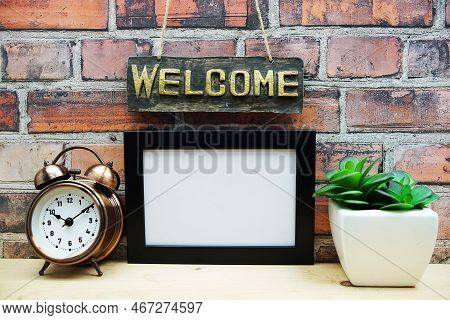 Empty Photo Frame Mock Up With Welcome Sign And Artficial Plant Home Decoration