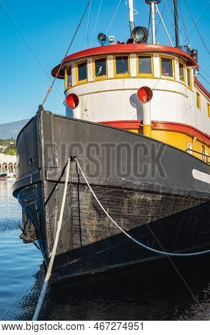 Old Tugboat In A Sunny Summer Day. Tug Boats Are Working In A Harbor. Offshore Supply Boat In A Calm