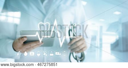 Doctor Using Digital Tablet With Medical Icon And Heartbeat Rate In The Hospital Background