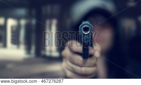 Woman Pointing A Gun At The Target On Dark Background, Selective Focus On Front Gun, Vintage Color T