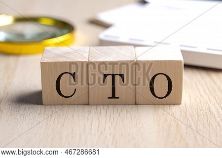 Cto On A Wooden Cubes With Magnifier And Calculator, Financial Concept Background