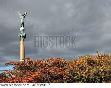 Copenhagen, Denmark - Oct 19, 2018: Bronze Angel Sculpture On The Ivar Huitfeldt Column Among Autumn