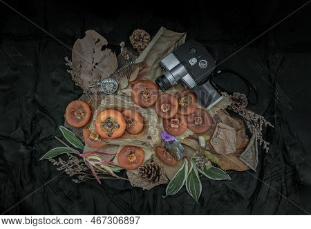 One Fresh Ripe Persimmon Fruit With Dried Persimmons On Dark Background. Winter Fruit, Top View, Spa