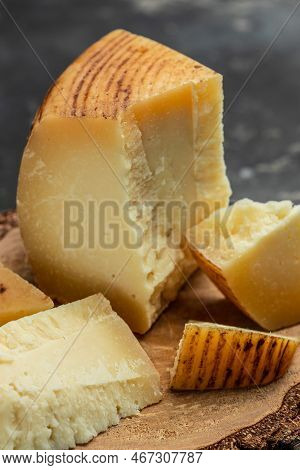 Gruyere Hard Yellow Cheese. A Traditional Swiss Hard Yellow Cheese Without Holes, With A Dark Crust 