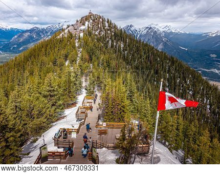 Canadian Flag Atop Goldola Summit With Sanson Peak Behind It