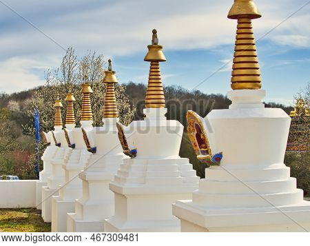 La Boulaye, France - April Circa, 2018. Several Small White Stupas With Traditional Eyes Of Buddha P