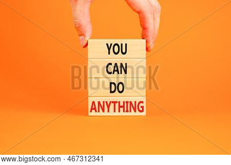 You Can Do Anything Symbol. Concept Word You Can Do Anything On Wooden Blocks. Businessman Hand. Bea