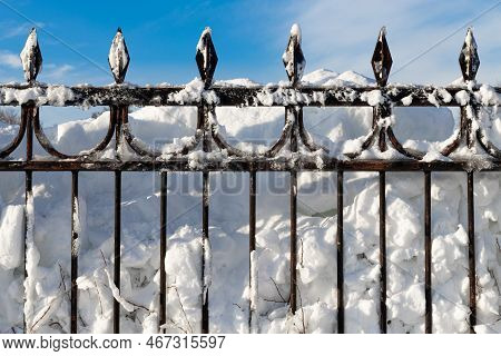 Metal Fence Covered With Snow After A Snowfall. City After Snowfall. Snow Covered Fence.