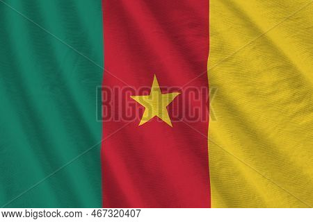 Cameroon Flag With Big Folds Waving Close Up Under The Studio Light Indoors. The Official Symbols An