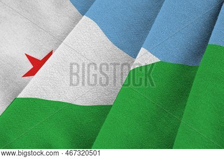Djibouti Flag With Big Folds Waving Close Up Under The Studio Light Indoors. The Official Symbols An