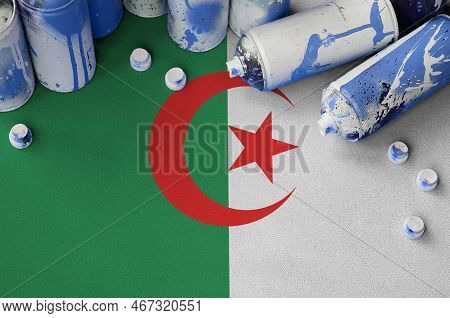 Algeria Flag And Few Used Aerosol Spray Cans For Graffiti Painting. Street Art Culture Concept, Vand