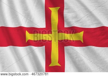 Guernsey Flag With Big Folds Waving Close Up Under The Studio Light Indoors. The Official Symbols An