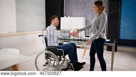 Business Person In Wheel Chair Shaking Hands