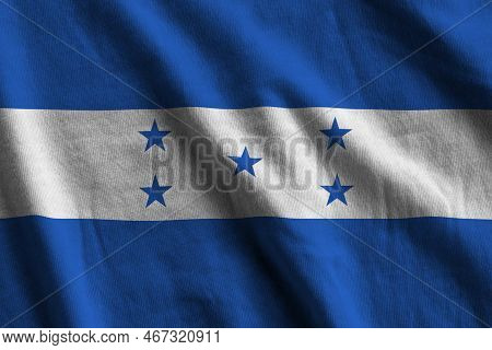 Honduras Flag With Big Folds Waving Close Up Under The Studio Light Indoors. The Official Symbols An