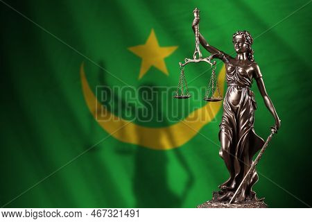 Mauritania Flag With Statue Of Lady Justice And Judicial Scales In Dark Room. Concept Of Judgement A