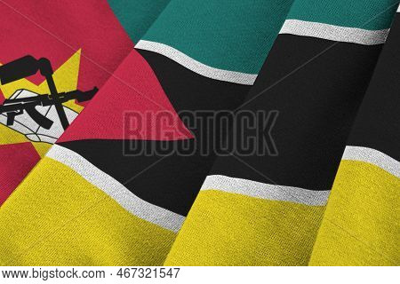 Mozambique Flag With Big Folds Waving Close Up Under The Studio Light Indoors. The Official Symbols 