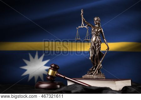 Nauru Flag With Statue Of Lady Justice, Constitution And Judge Hammer On Black Drapery. Concept Of J
