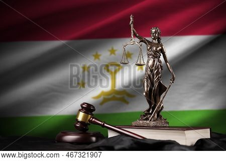 Tajikistan Flag With Statue Of Lady Justice, Constitution And Judge Hammer On Black Drapery. Concept
