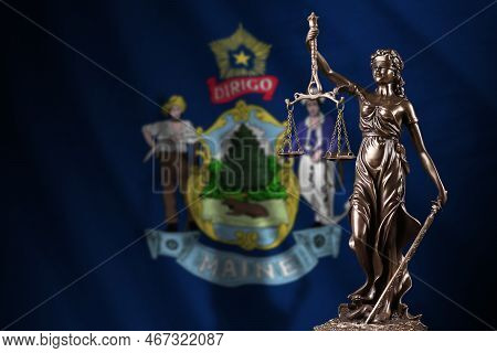 Maine Us State Flag With Statue Of Lady Justice And Judicial Scales In Dark Room. Concept Of Judgeme