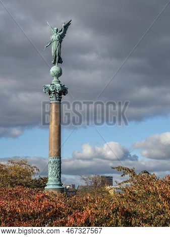 Copenhagen, Denmark - Oct 19, 2018: Bronze Angel Sculpture On The Ivar Huitfeldt Column Among Autumn