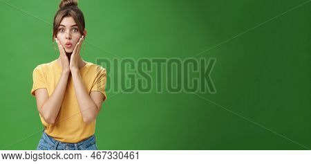 Silly Cute And Tender Young Female Model With Cleacn Skin Folding Lips, Pressing Hands To Cheeks And