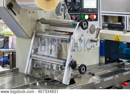 Close Up Transparent Plastic Stretch Film Sheet During Process On Automatic Wrapping Or Packing Mach