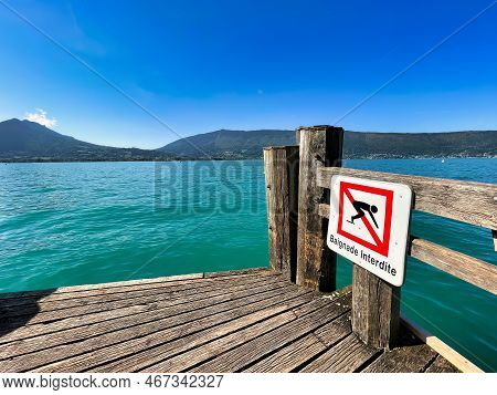 Menthon Saint Bernard, France - September 12 2021 : A French Sign Warning Placed On A Wooden Jetty O