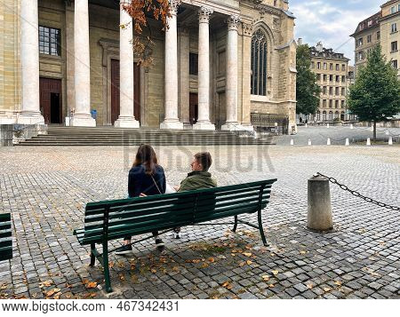 Geneva, Switzerland - September 15 2021: A Couple Is Sitting Romantic On A Square In The Old Town Wi