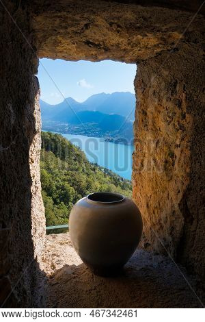 Talloires, France - September 09 2021 : Window With Ivy Made In Cave Stones By Monks With Mountain V