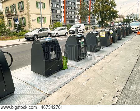 Geneva, Switzerland - September 14 2021: A Long Row Of Recycling Contaiiners Has Been Placed On A Ci