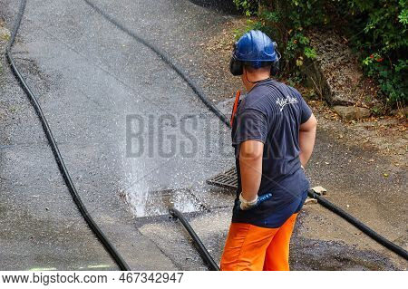 Menthon Saint Bernard, France - September 09 2021: A Professional Worker Is Busy With A Pump Car And