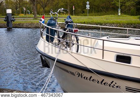 Voorburg, Netherlands - May 04 2021: A Typical Dutch View Of A Bicycle Parked On The Deck Of A Boat 