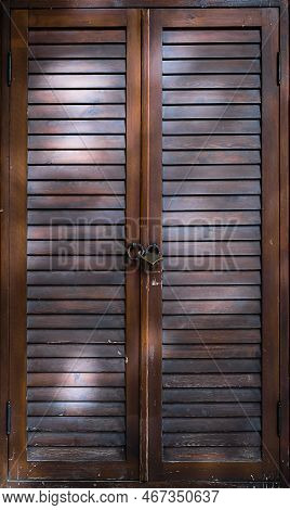 Wooden Door With Ventilation From Lamellas, Sun Protection Blinds Door Closed With A Padlock, Close-