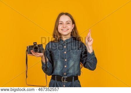 Happy Superstitious Girl Photographer Holding Photo Camera Keeping Fingers Crossed, Luck