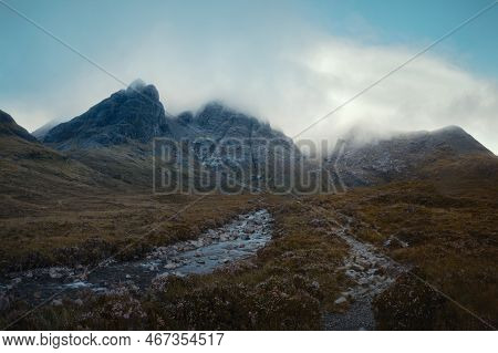 The Morning Panorama Of The River And The Footpath Leading To The Cloud-covered Mountain Peaks. Scen