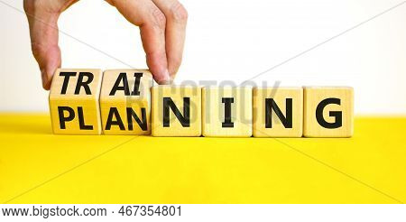 Training And Planning Symbol. Concept Word Training And Planning On Wooden Cubes. Businessman Hand. 