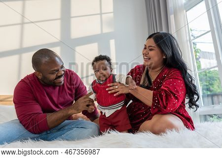 African Family, Nigerian Father And Asian Mother Holding A 4-month-old Baby Newborn Son, They Are Sm